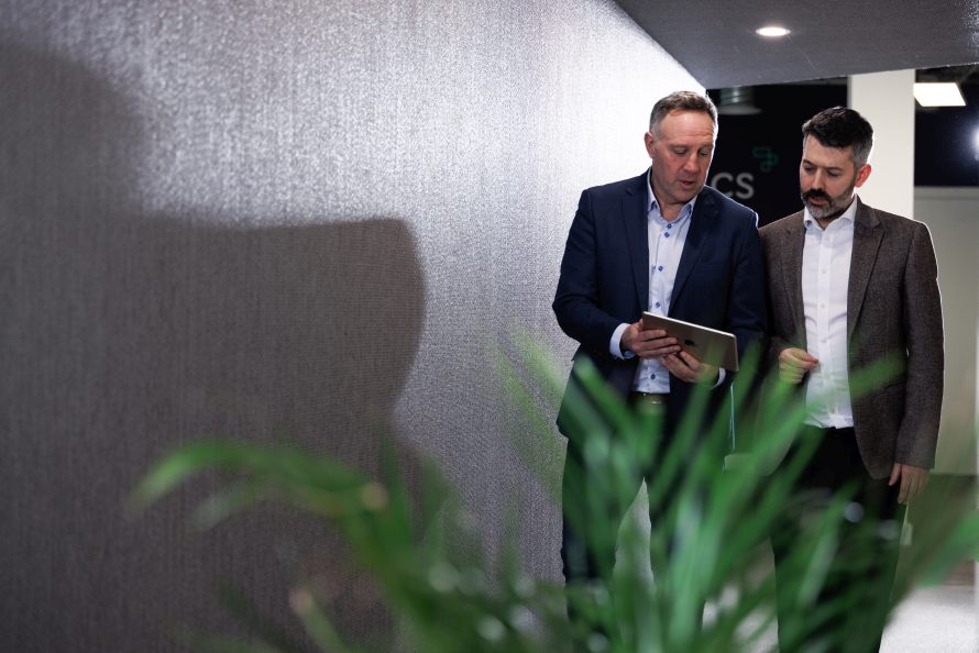 2 men walking with tablet cloud support